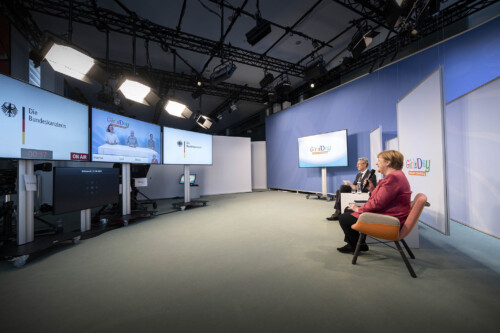 Bundeskanzlerin Angela Merkel und D21-Präsident Hannes Schwaderer sprechen mit einer Schülerinnen-Gruppe
im John-Lennon-Gymnasium via einem Live Stream